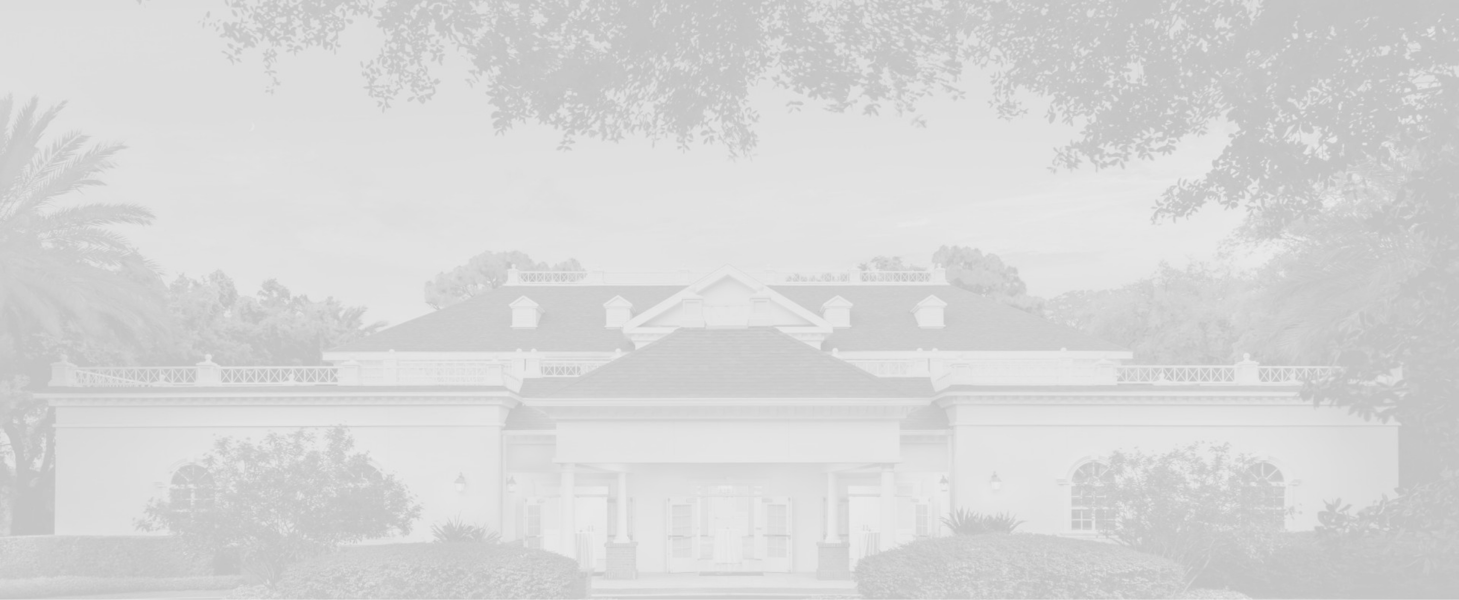 a grayscale photo of a large building with a symmetrical facade and a covered entrance