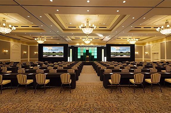 a room with chairs and a large screen