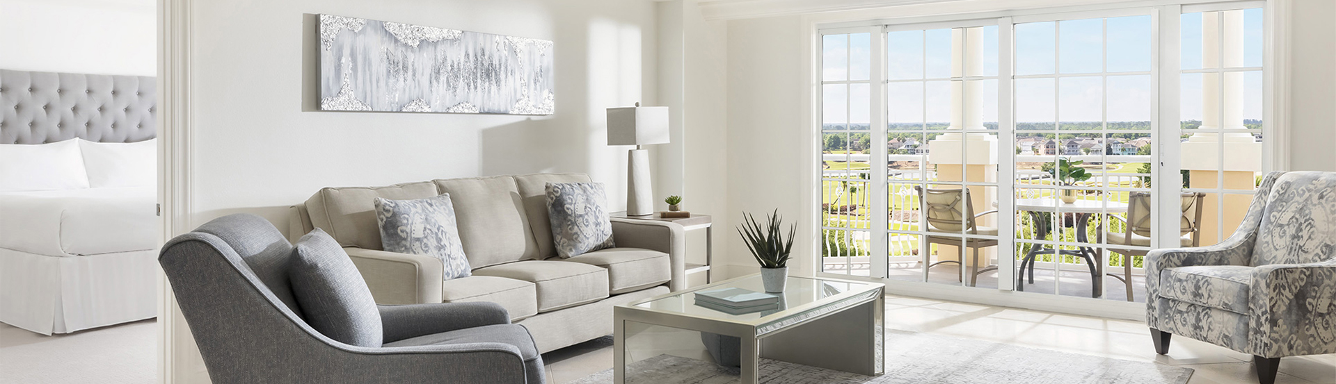 a living room with a couch and a glass coffee table