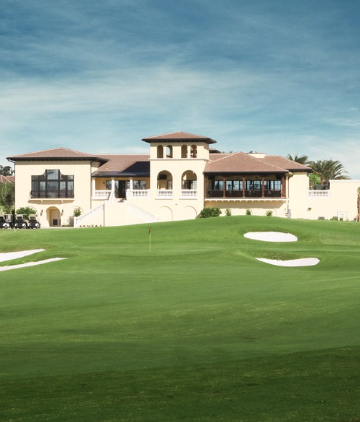 a large building with a golf course