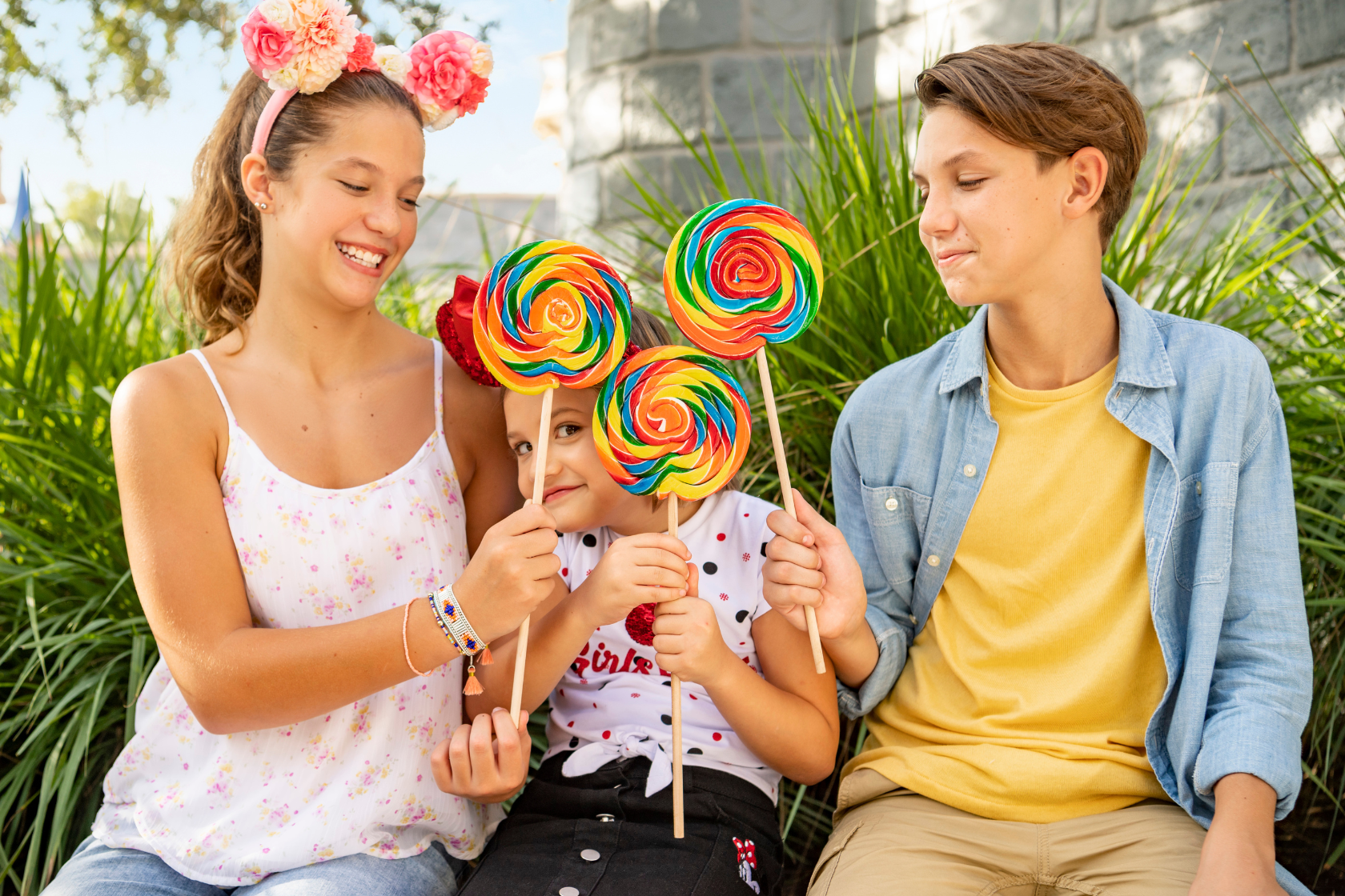 a group of people holding lollipops