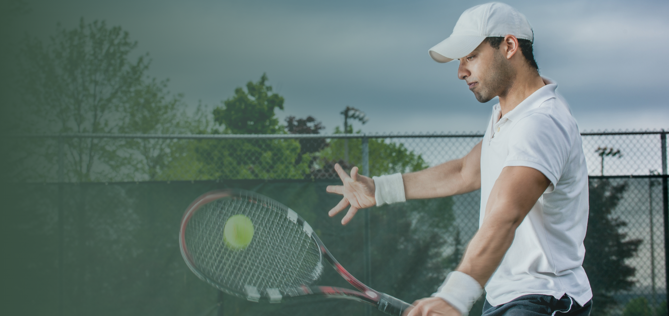 a man hitting a tennis ball with a racket