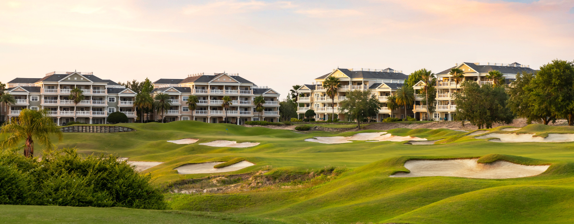 a golf course with a group of buildings