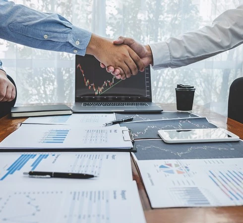 a handshake between two people on a table