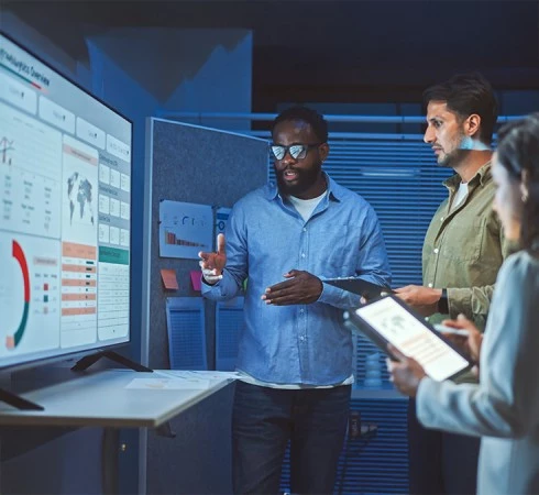 a group of people looking at a computer screen