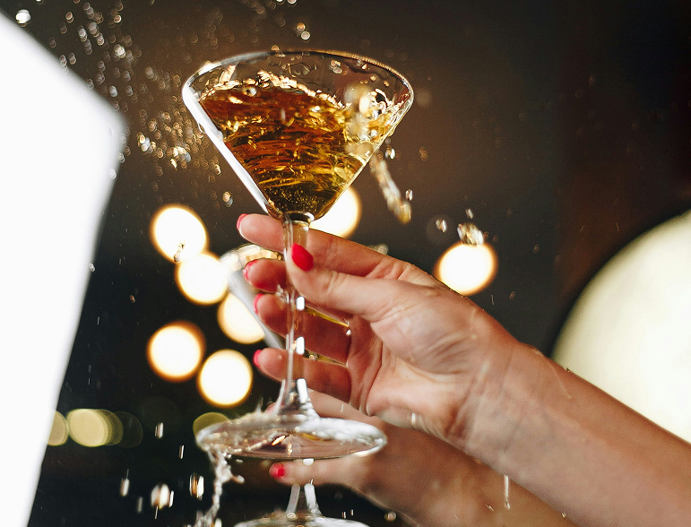a person holding a martini glass
