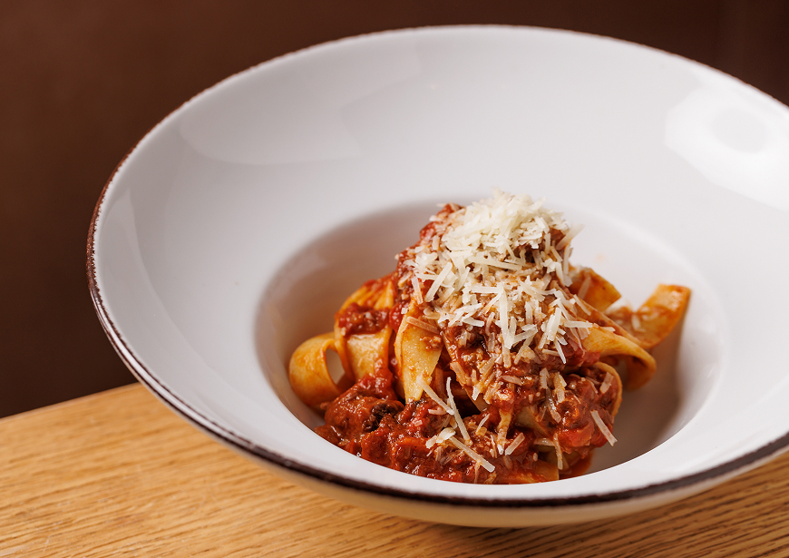 a bowl of pasta with sauce and cheese