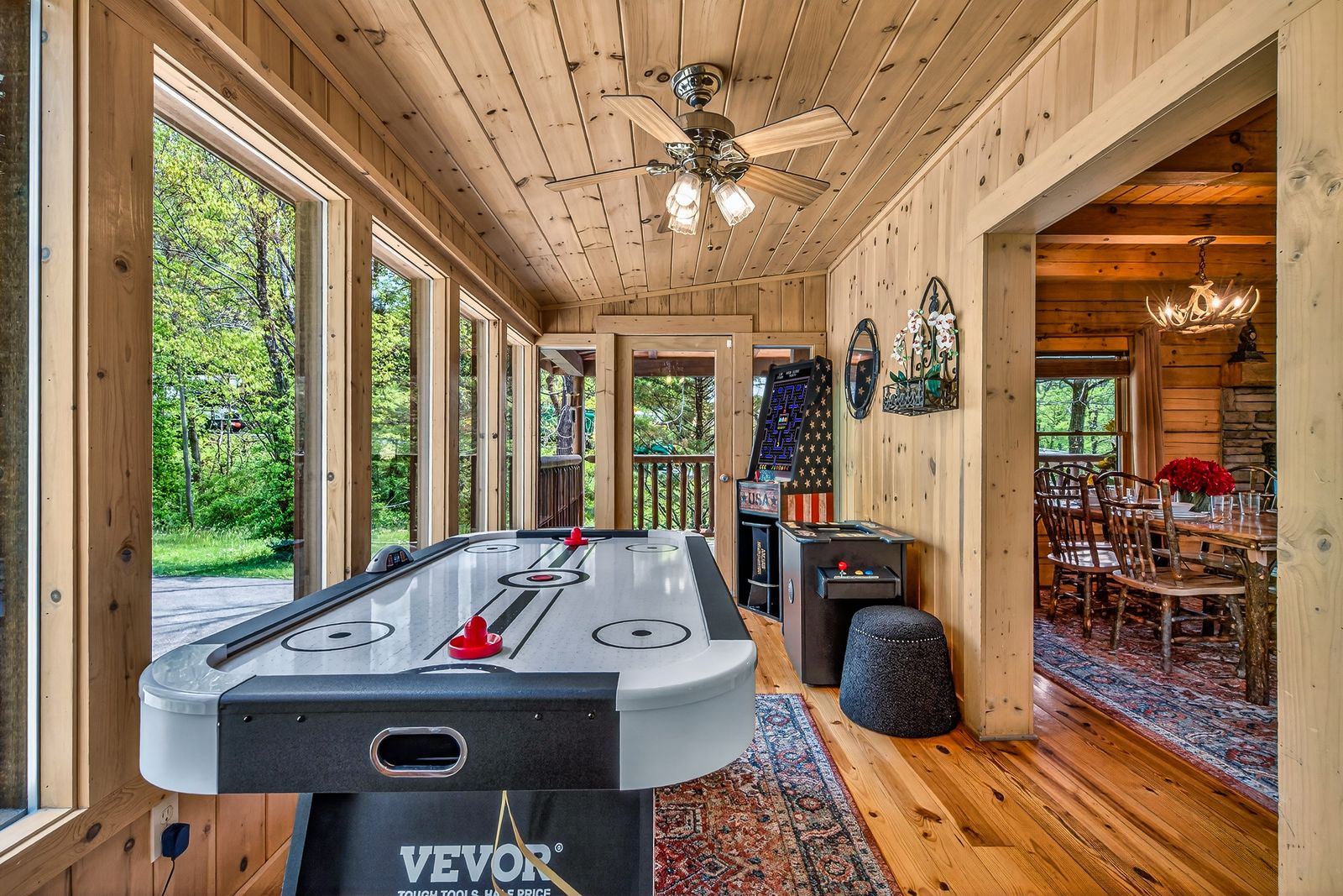 a game room with a table and a ceiling fan