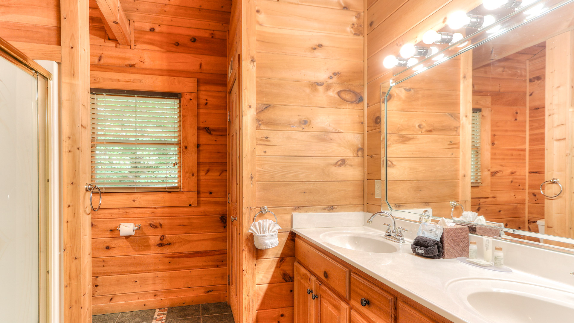 a bathroom with a wood wall and a mirror