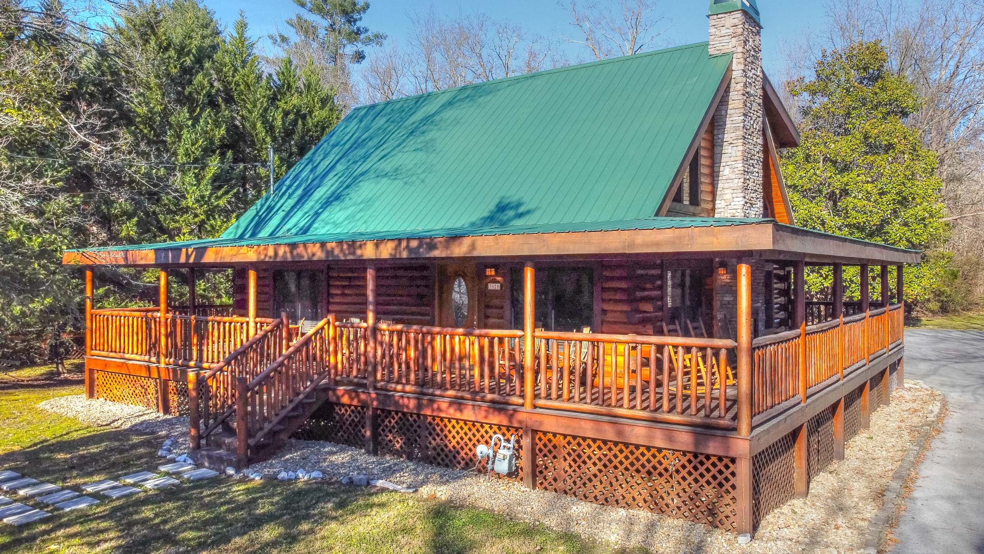 a log cabin with a green roof