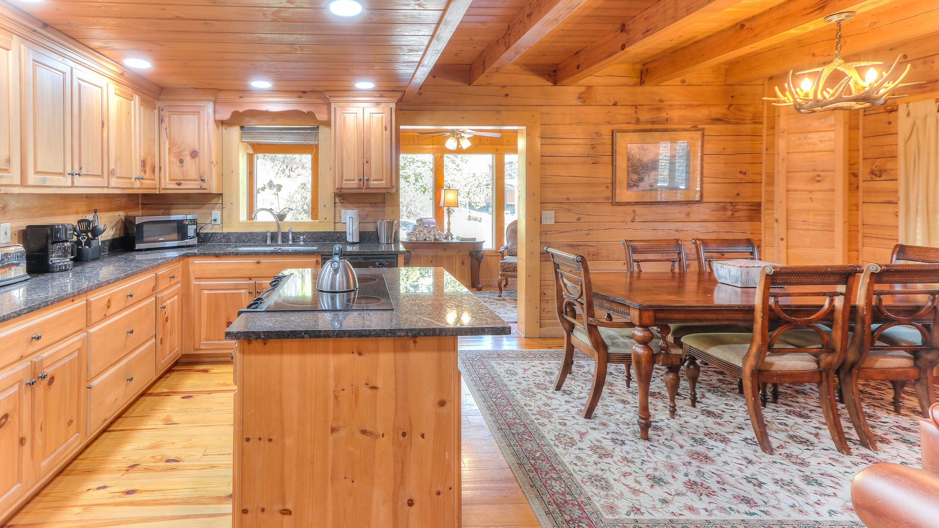 a kitchen and dining room in a log cabin