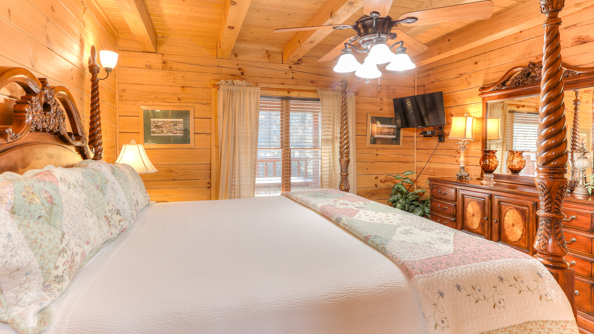 a bedroom with a large bed and a television