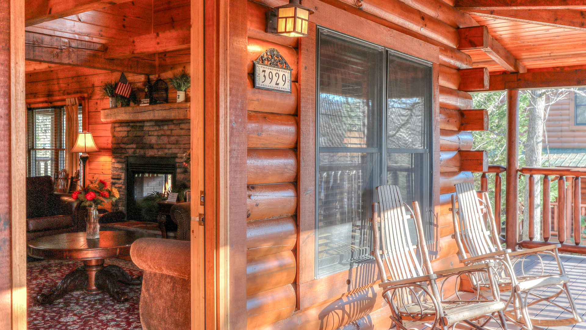a porch with chairs and a lamp on the side