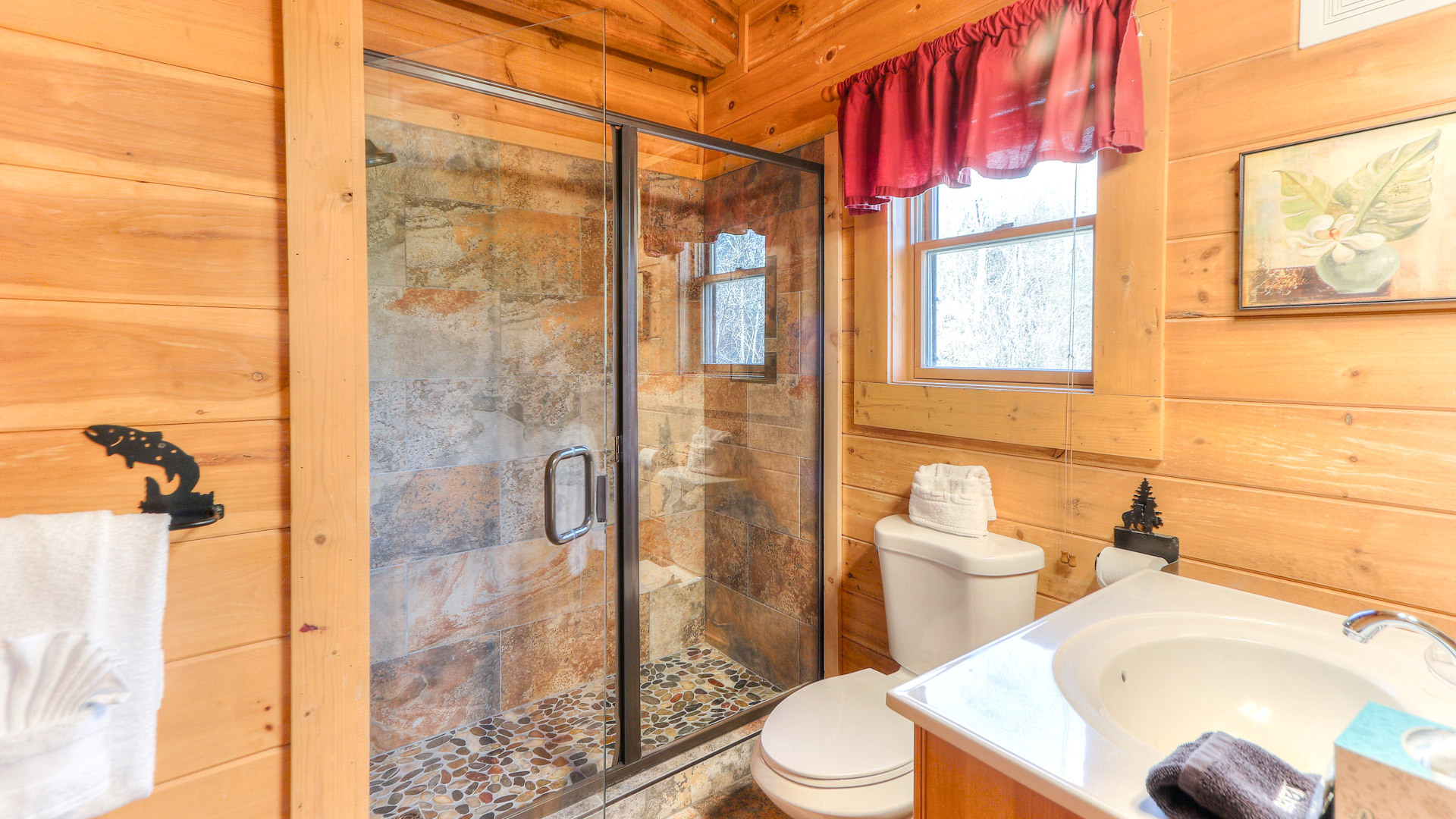 a bathroom with a glass shower and toilet