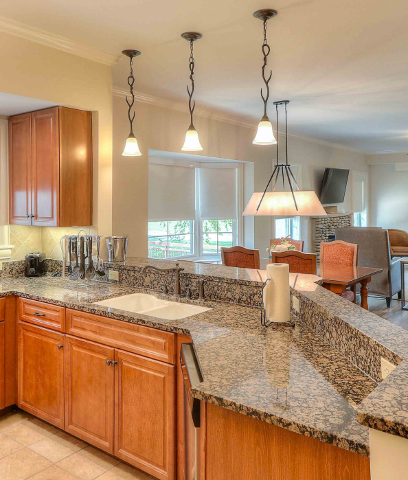 a kitchen with granite counter tops and a dining area