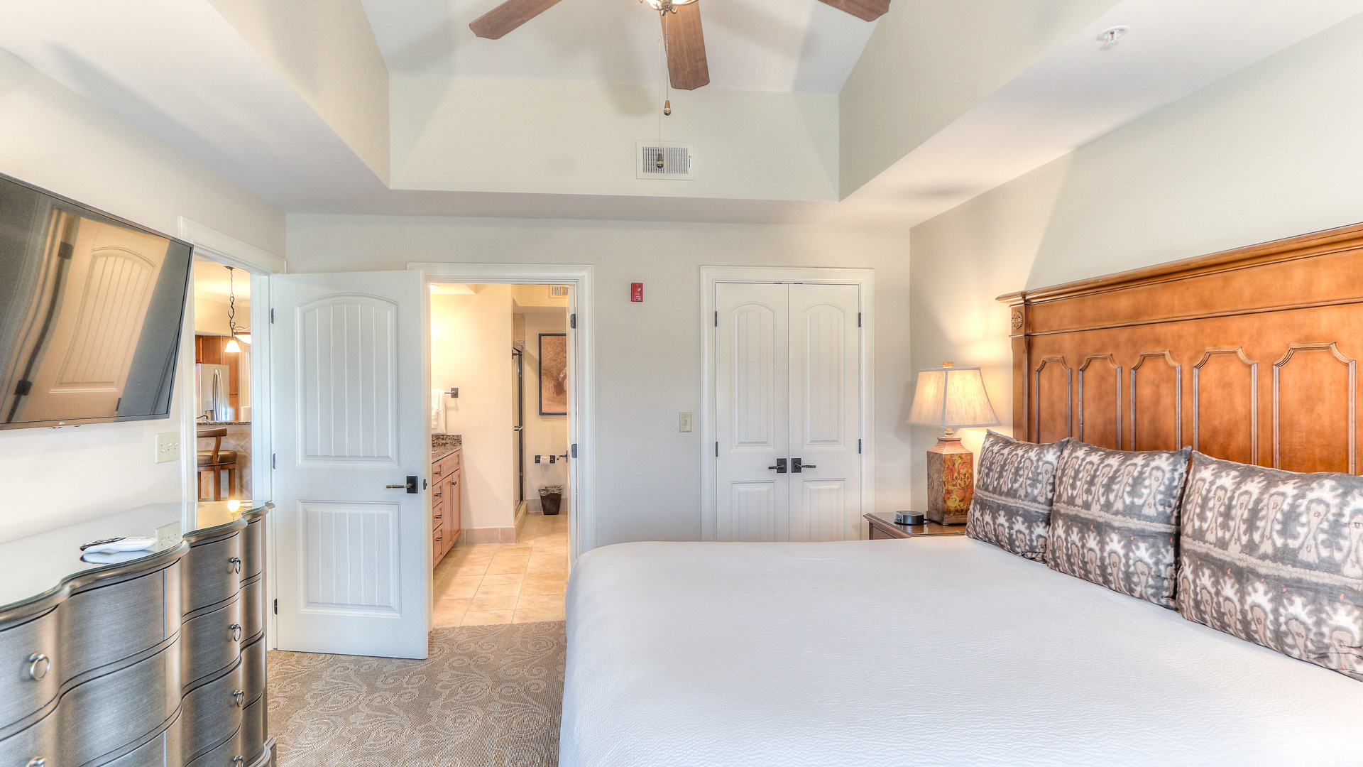a bedroom with a ceiling fan and a bed