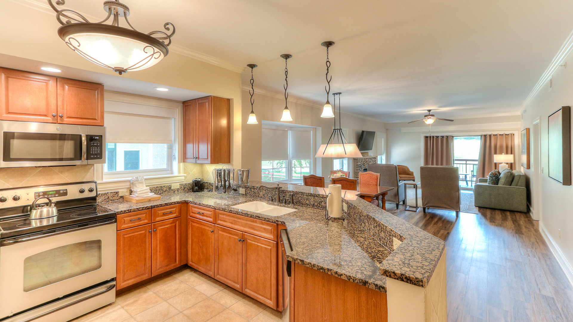 a kitchen with granite counter tops and a large dining area