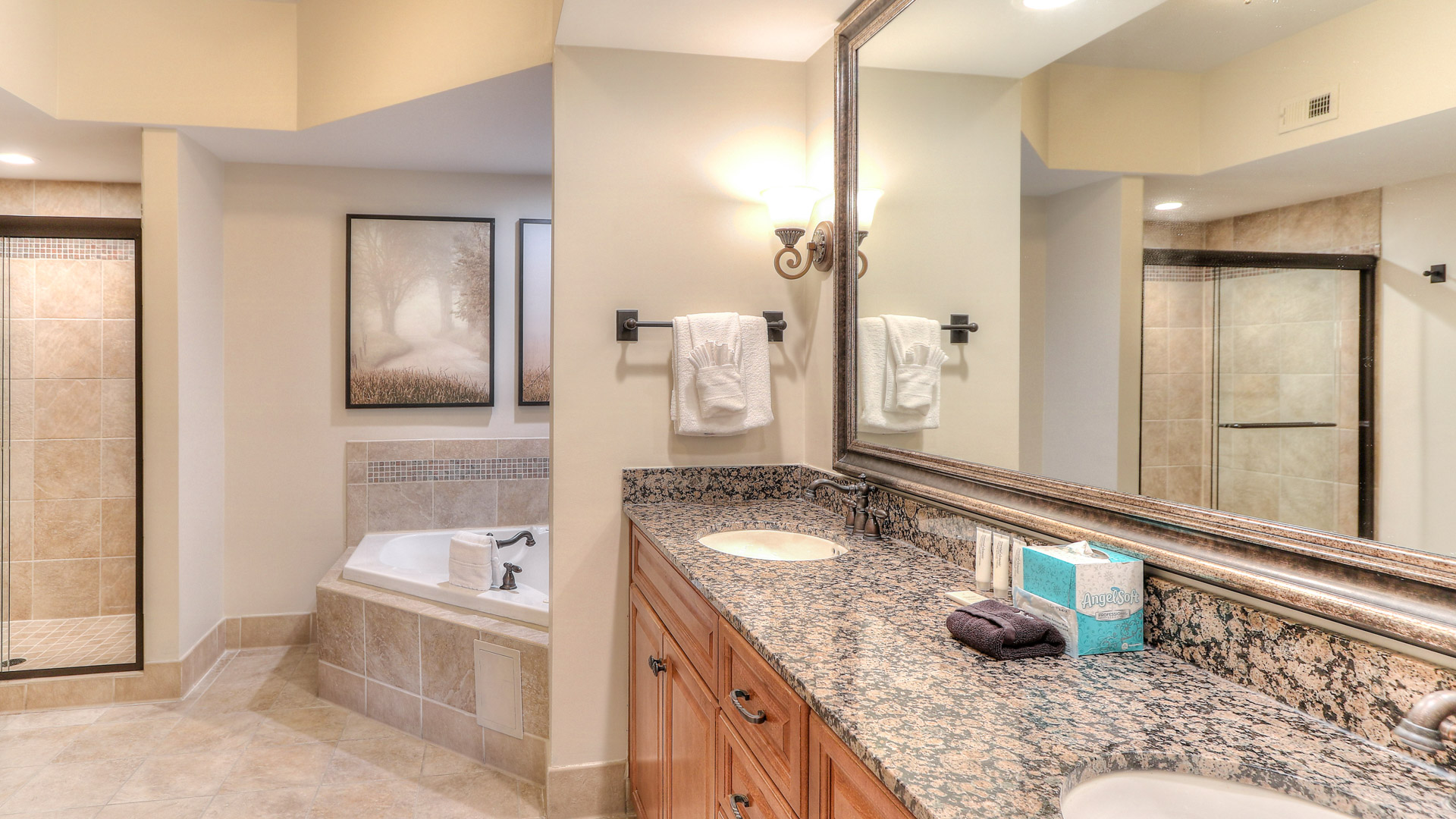 a bathroom with a large mirror and a tub