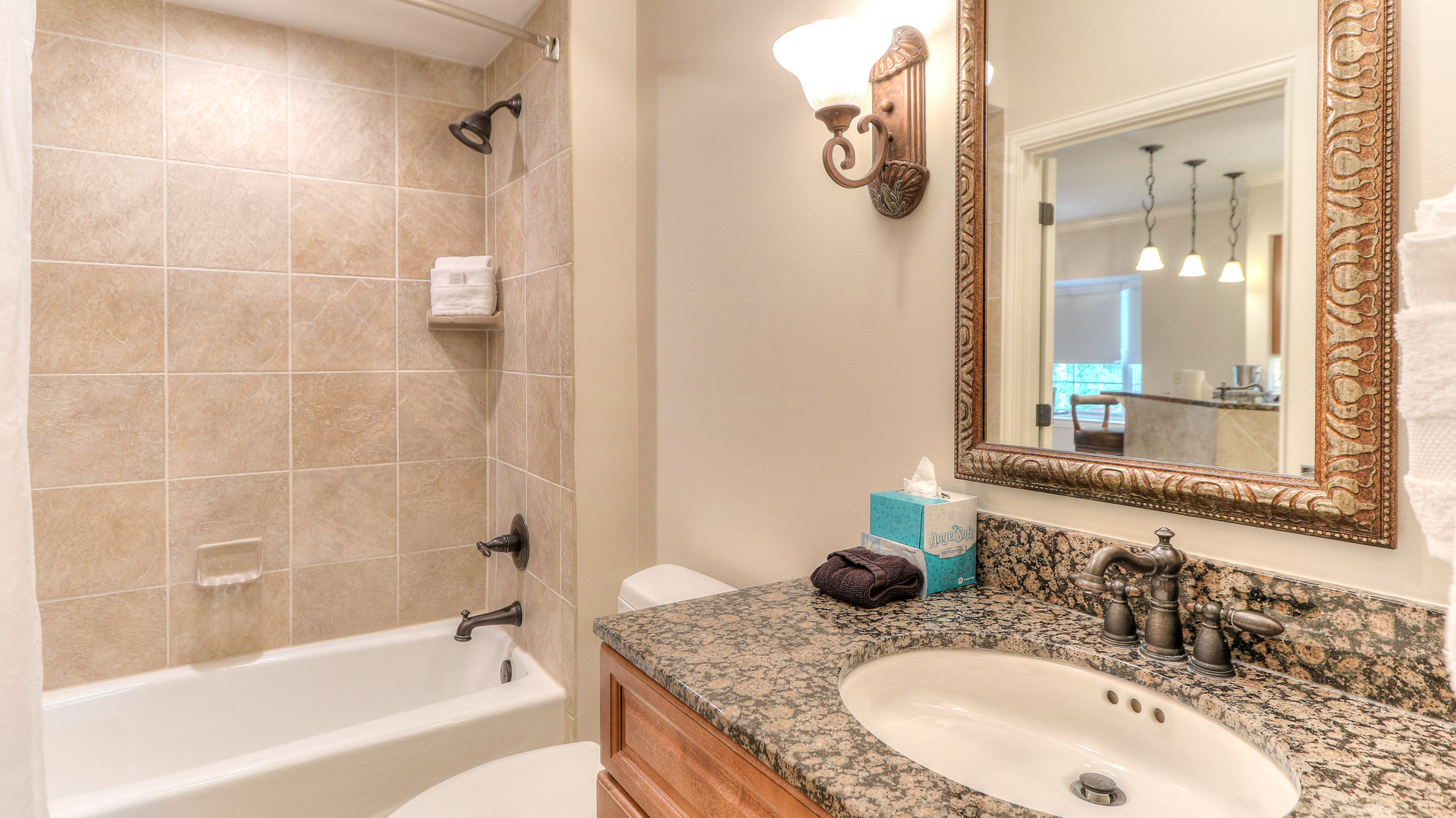a bathroom with a marble countertop and a bathtub