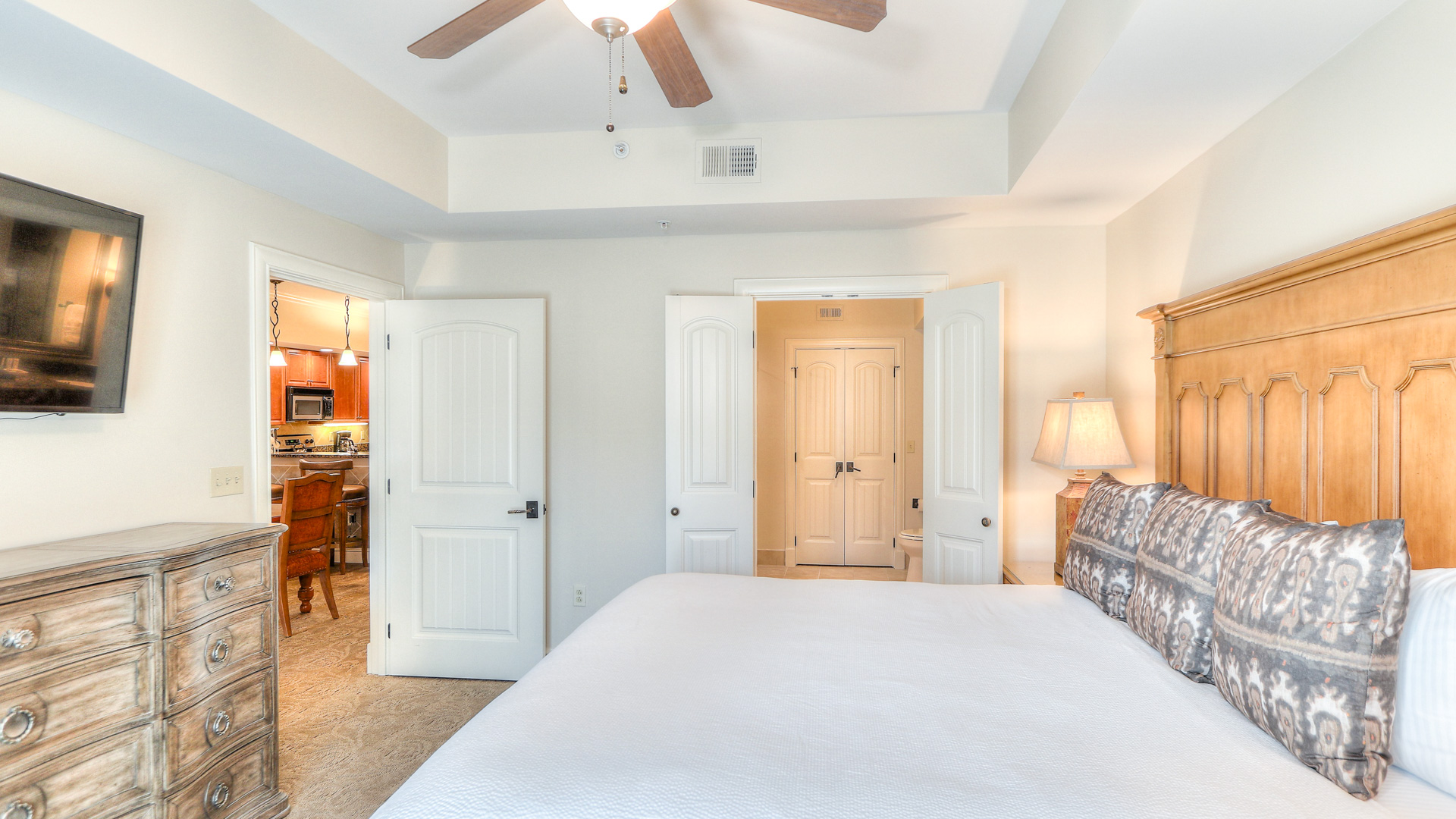 a bedroom with a ceiling fan and a bed