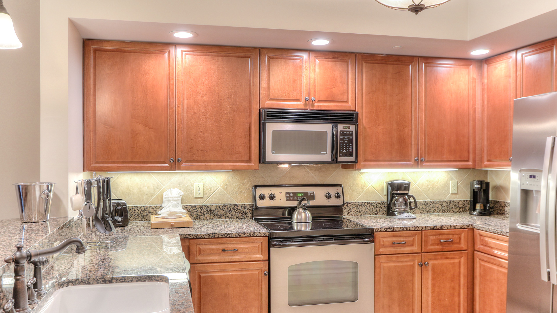 a kitchen with granite counter tops and cabinets