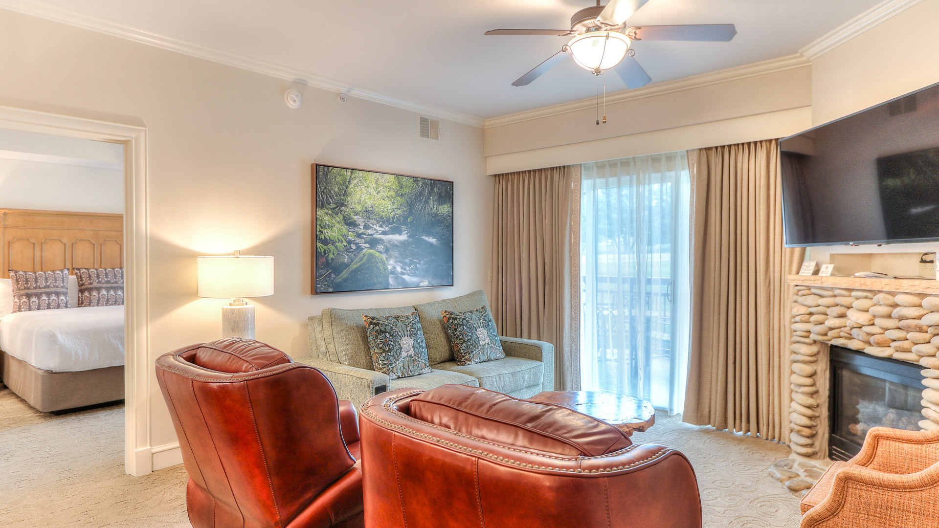 a living room with a couch and a fan
