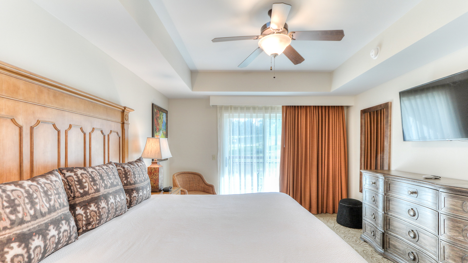 a bedroom with a bed and a ceiling fan