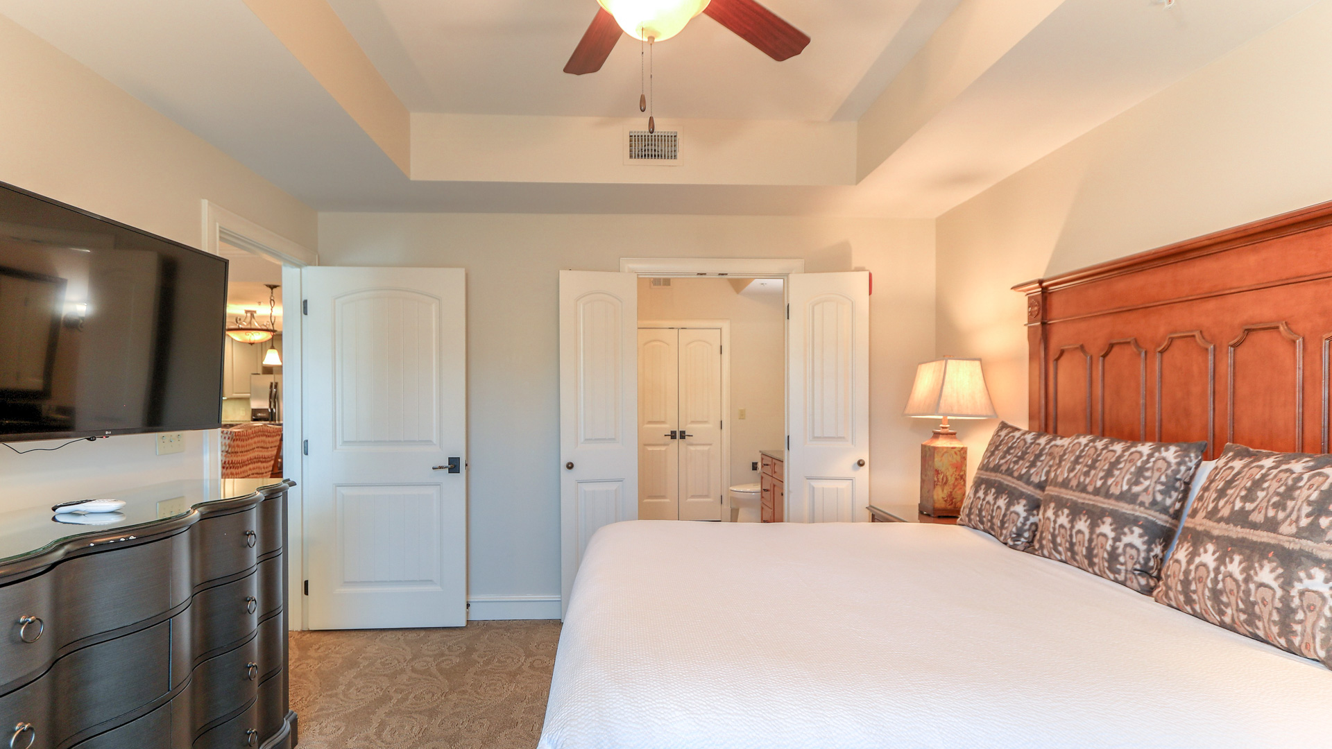 a bedroom with a ceiling fan and a bed