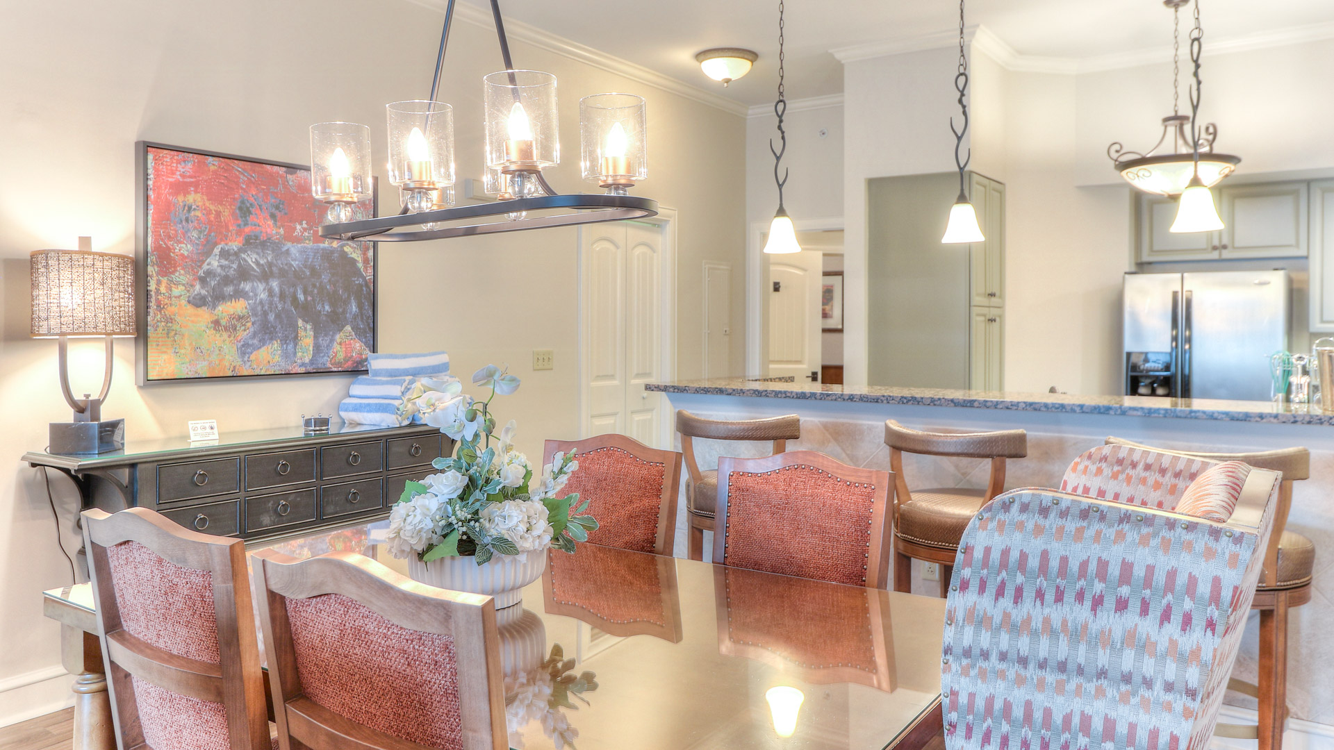 a dining table with chairs and a chandelier