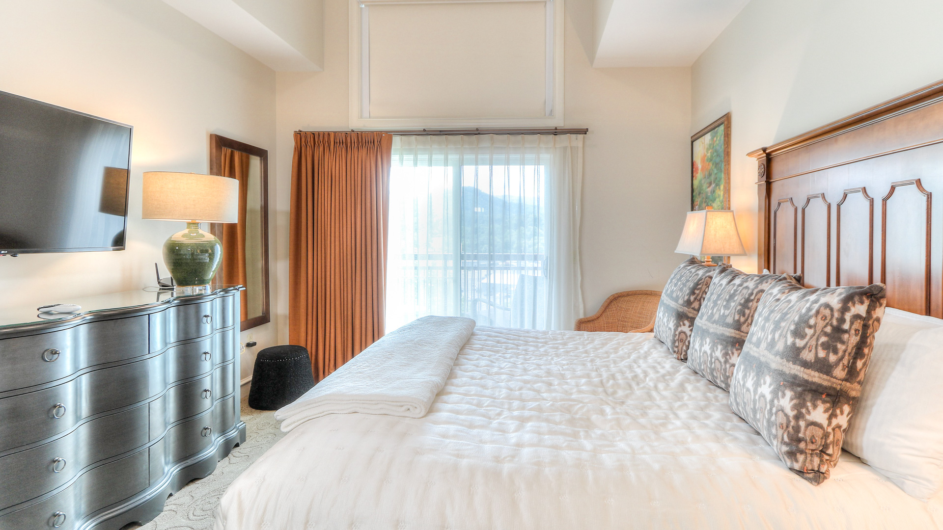 a bed with pillows and lamps in a room