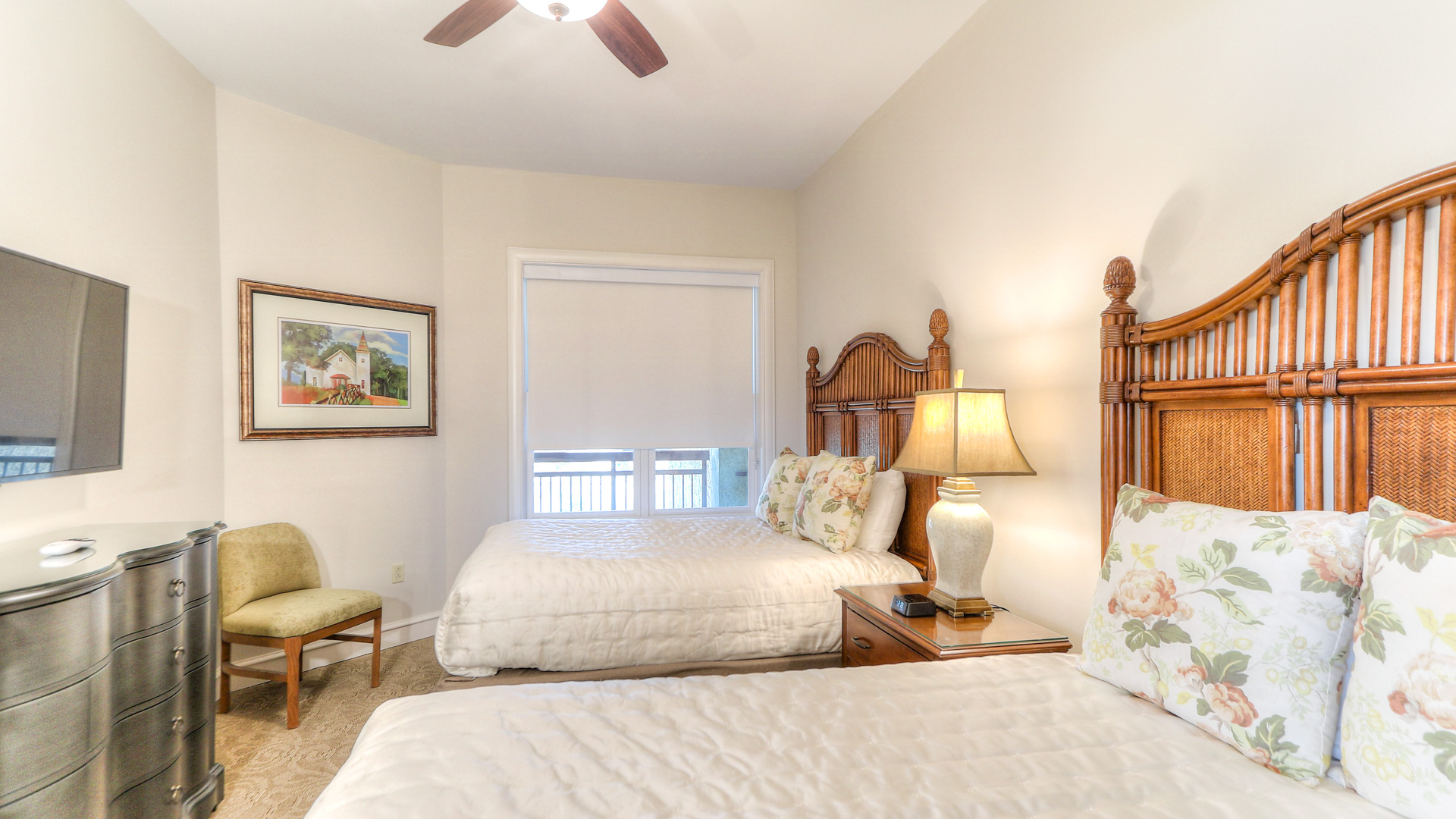 a bedroom with two beds and a lamp