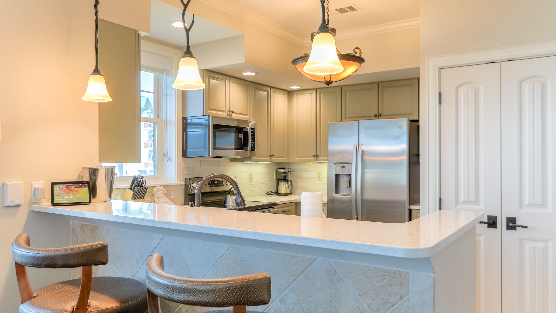 a kitchen with a bar and a refrigerator