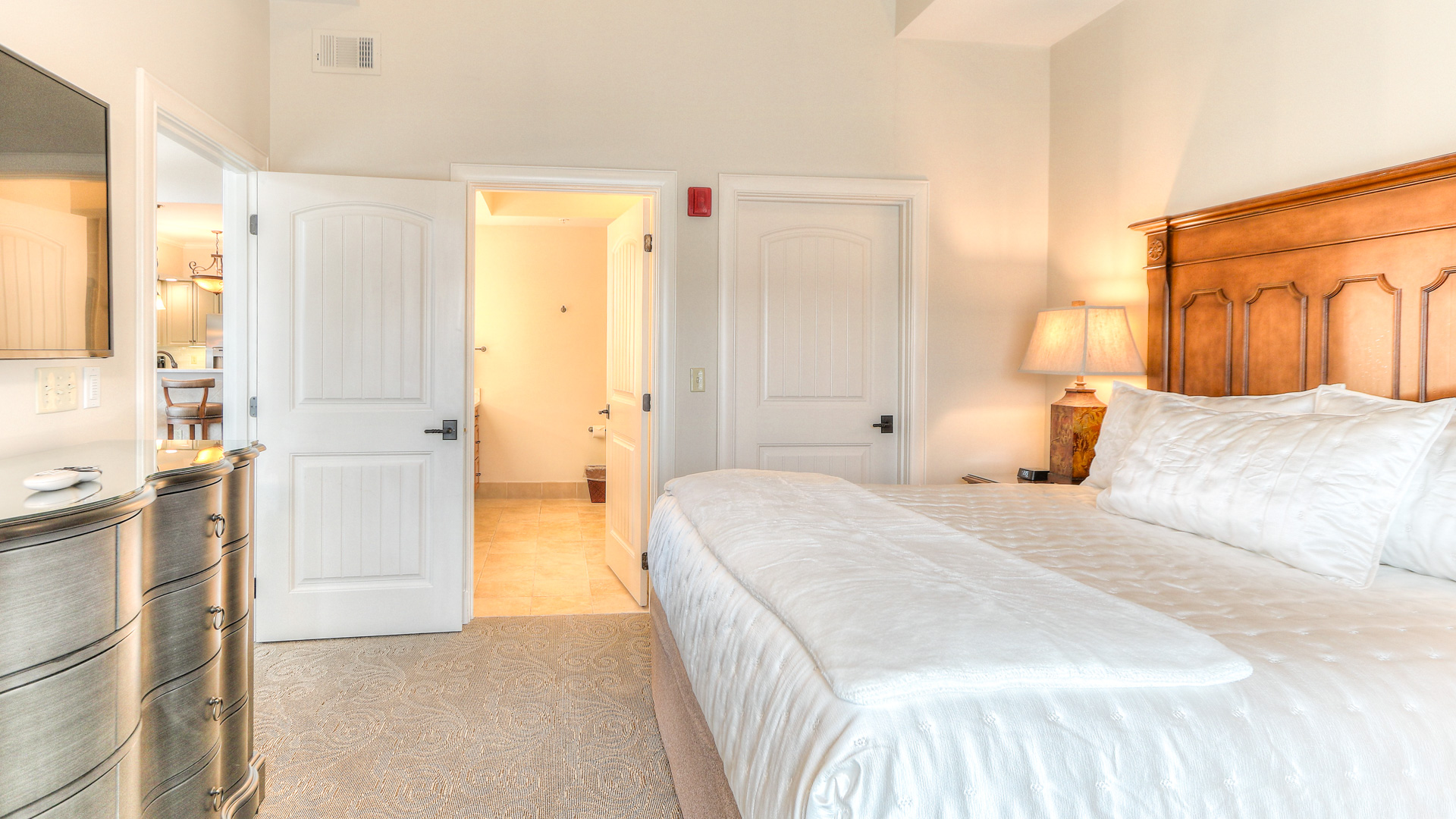 a bedroom with two doors open