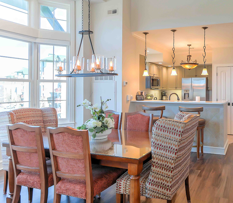 a dining room with a kitchen and dining table