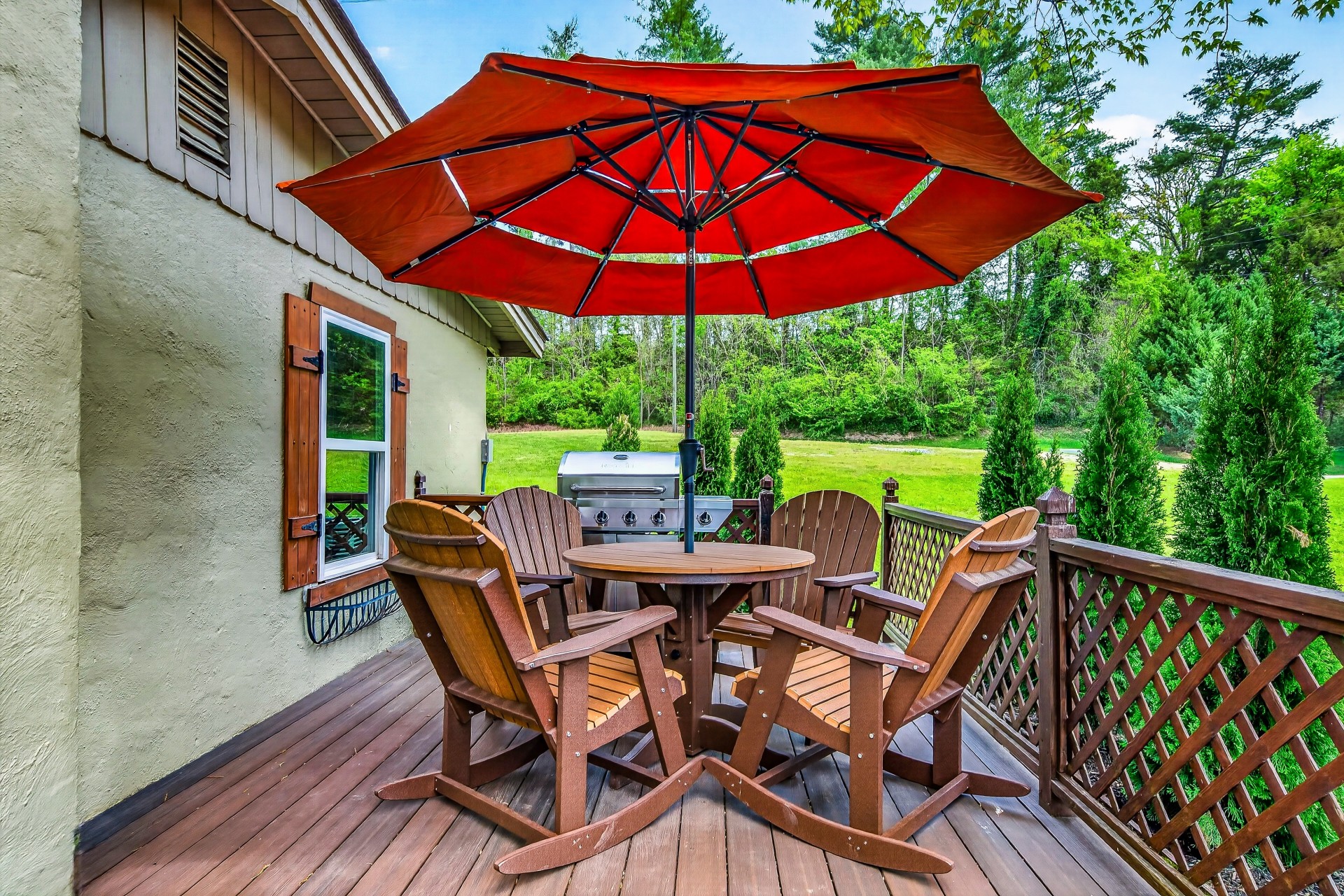 a patio with a table and chairs under an umbrella