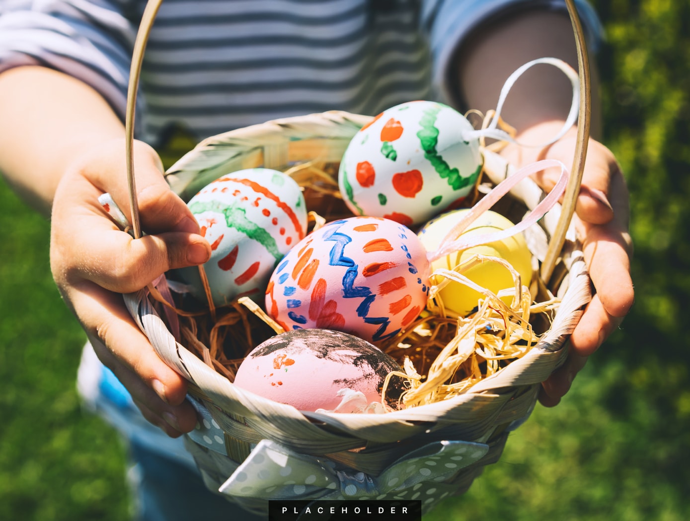 a person holding a basket of painted eggs