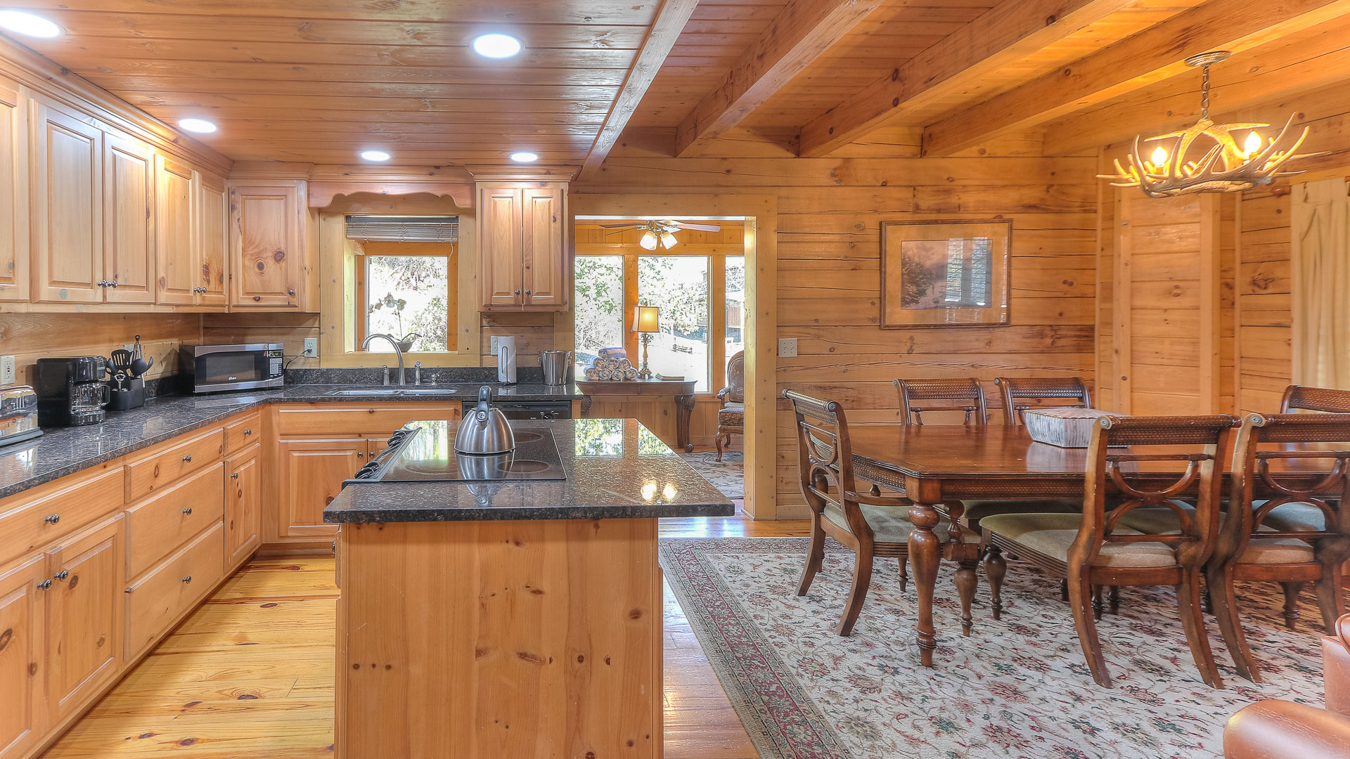 a kitchen and dining room in a log cabin
