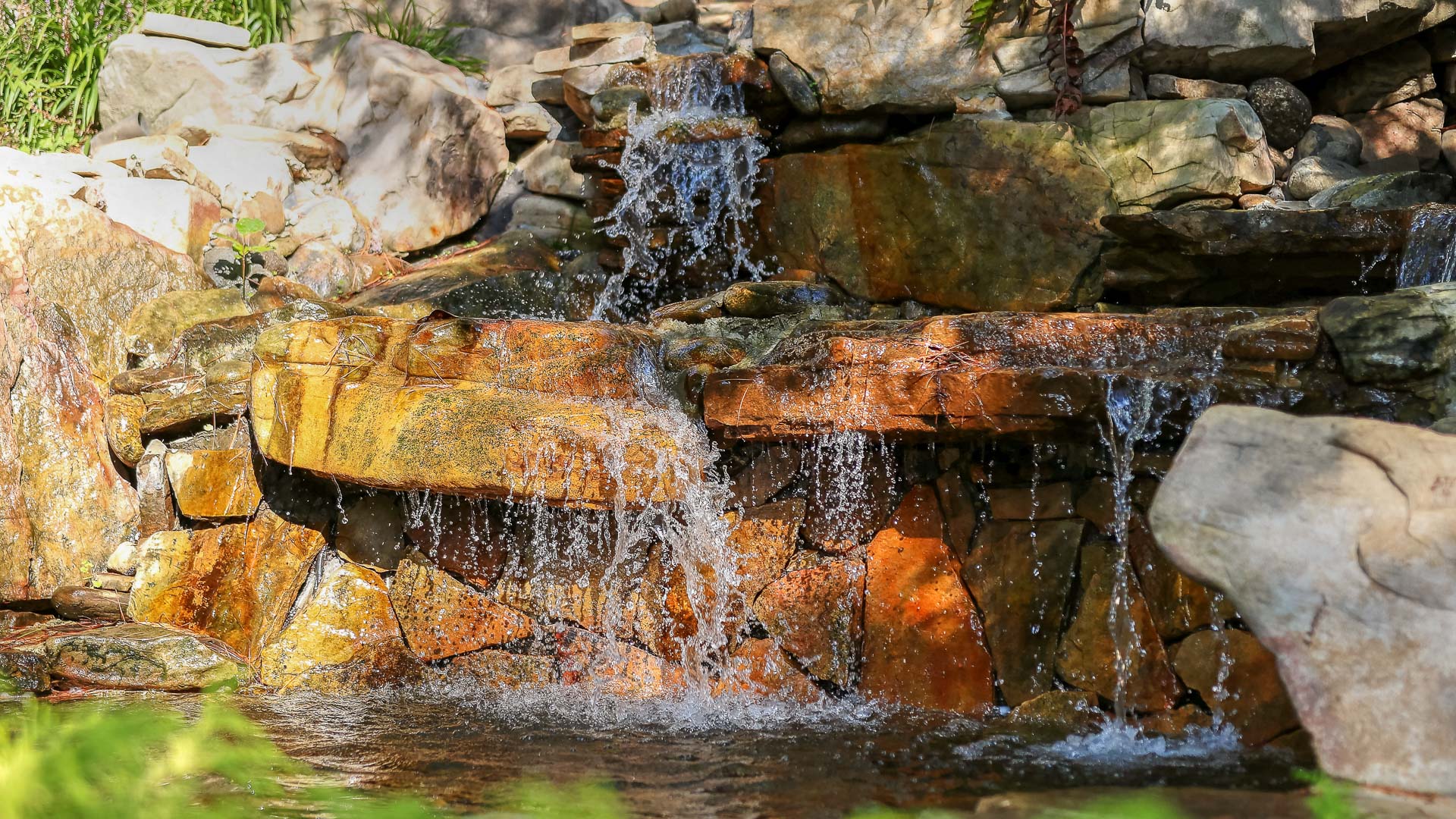 a waterfall with water falling over rocks