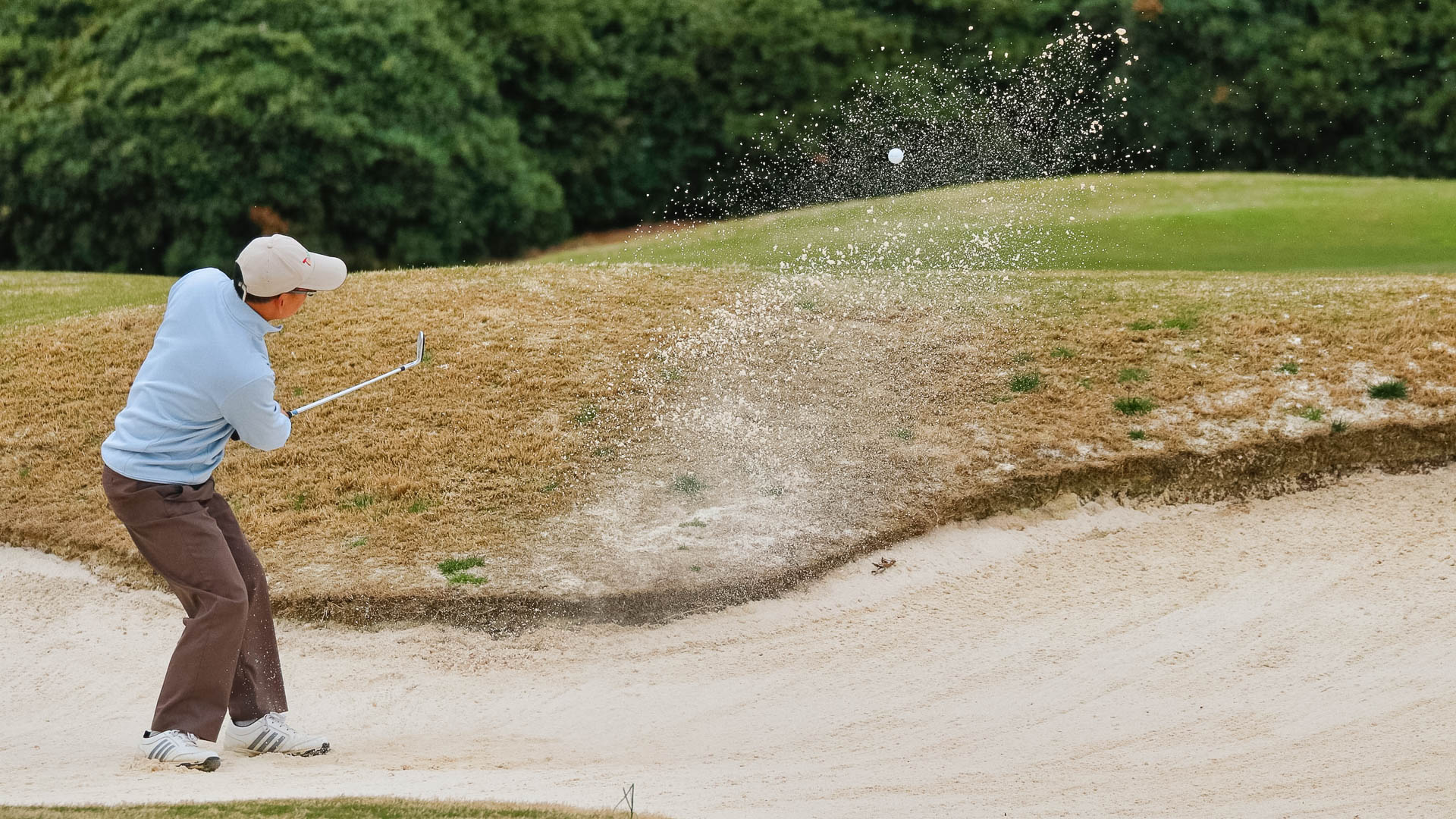 a person hitting a golf ball
