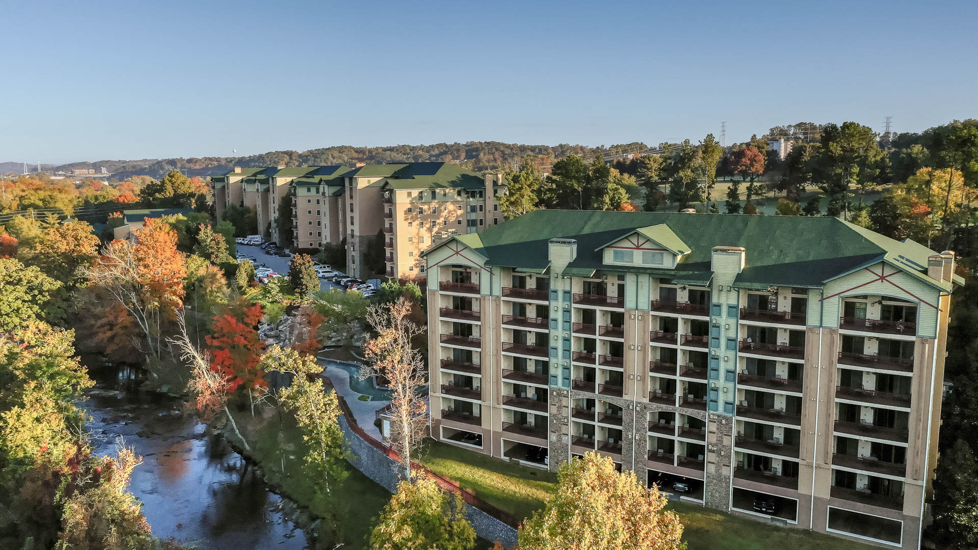 a building with trees and a river