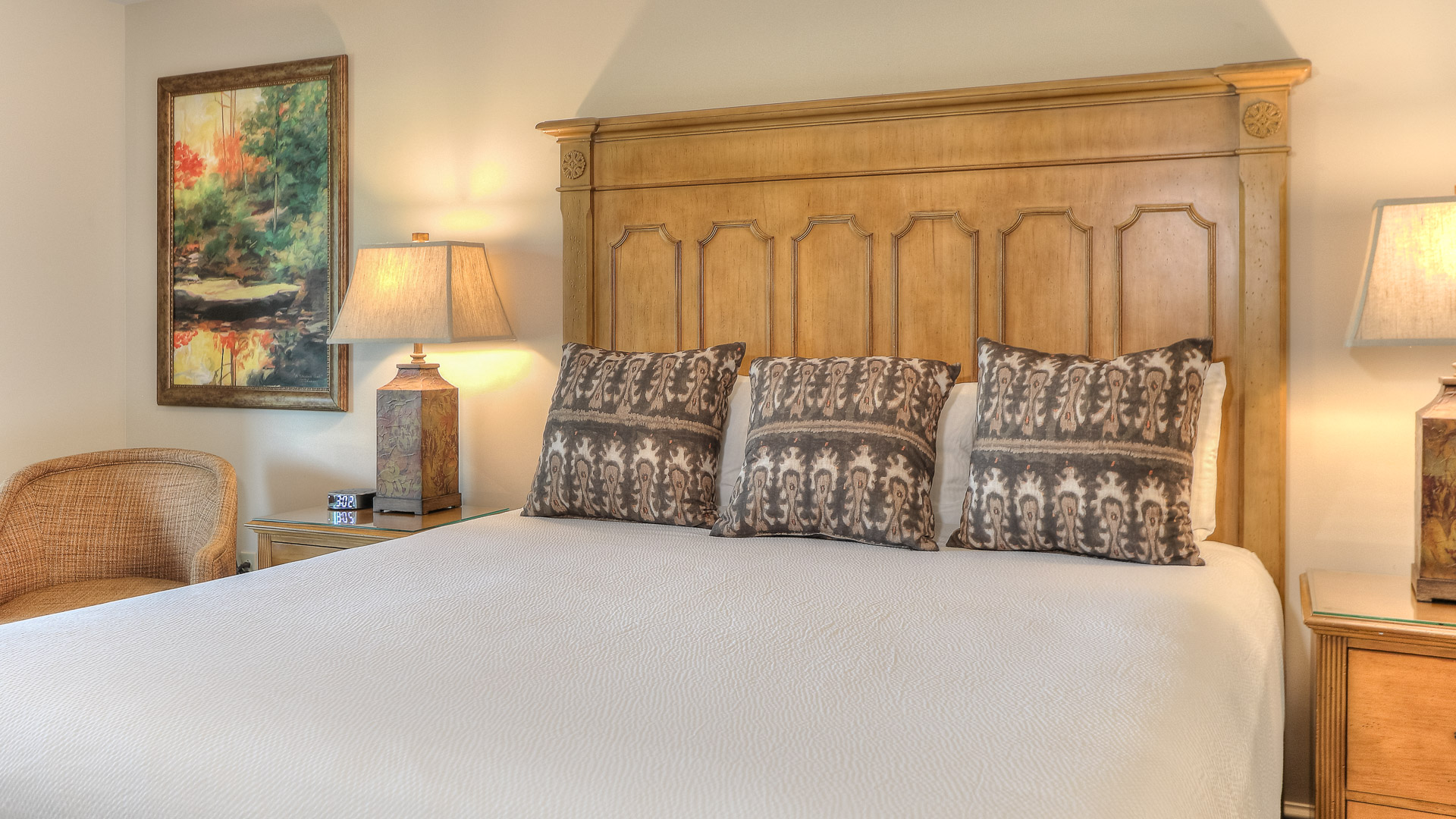 a bed with pillows and a lamp