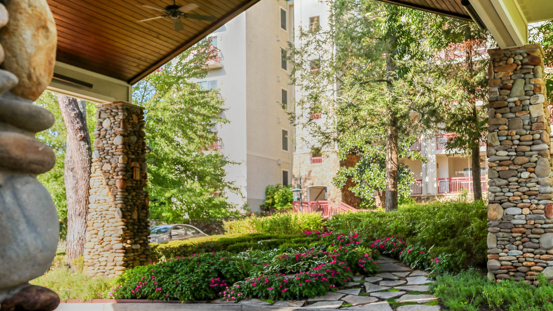 a patio with flowers and trees