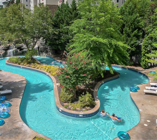 a pool with trees and people in it