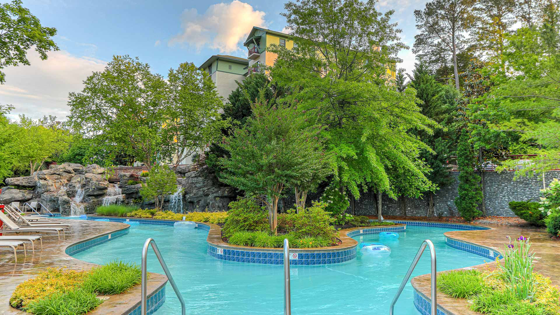 a pool with trees and a building in the background