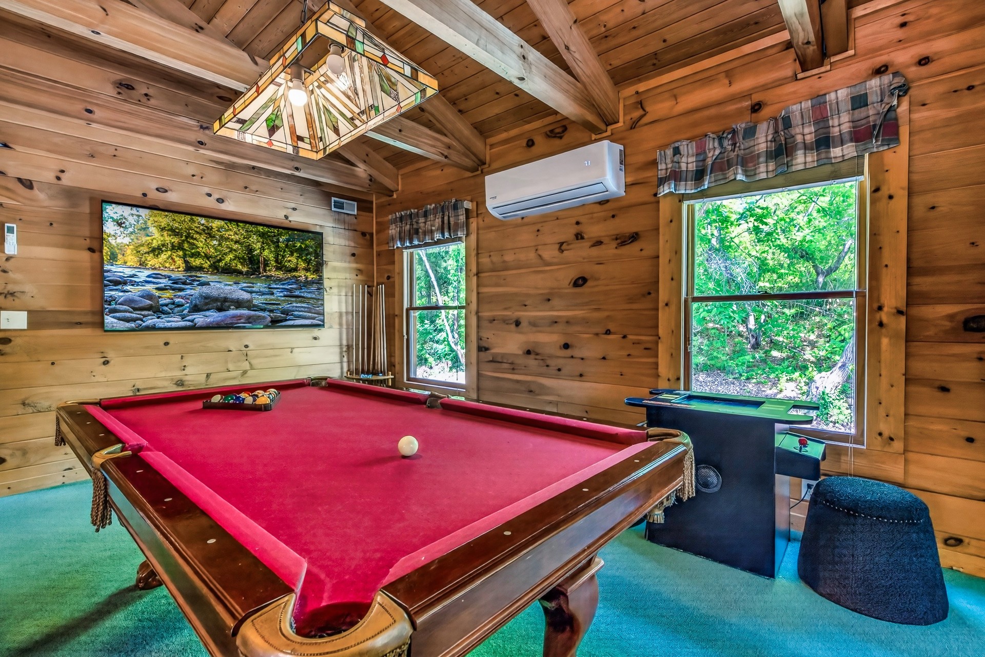 a pool table in a log cabin