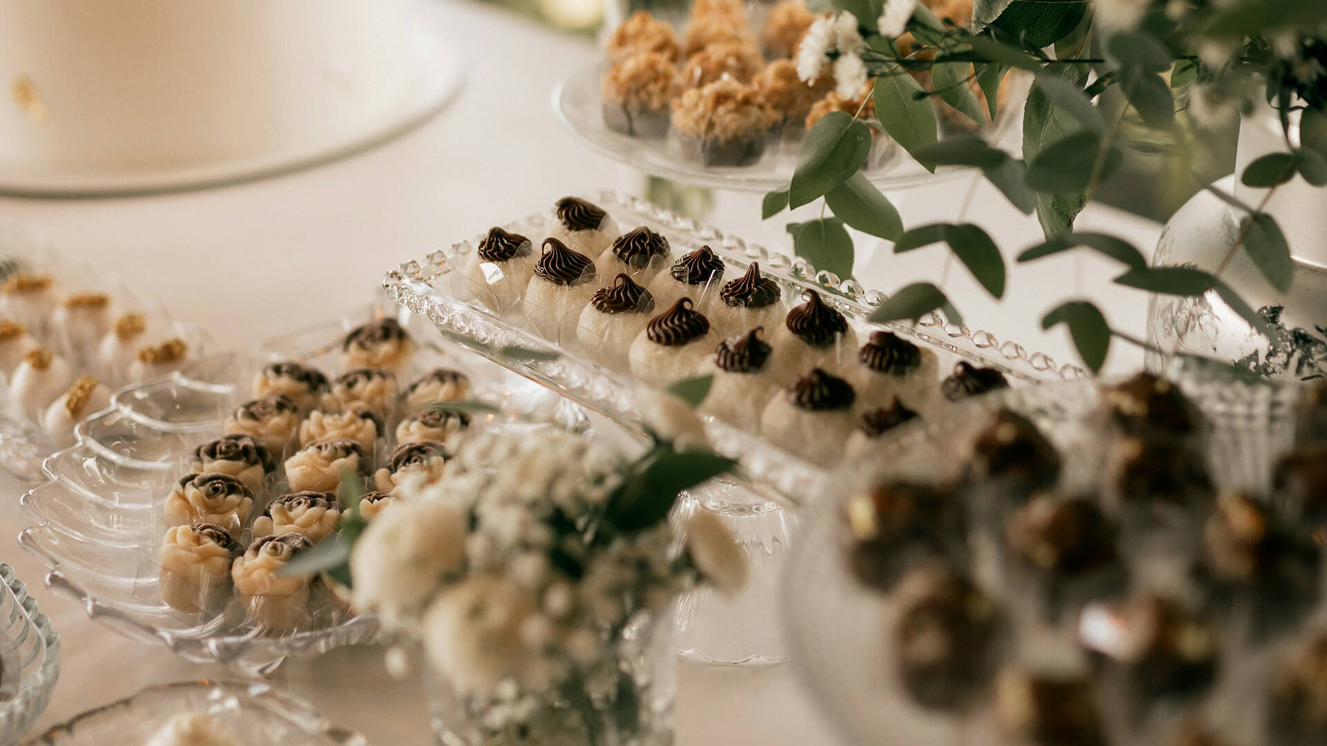 a table with desserts and flowers