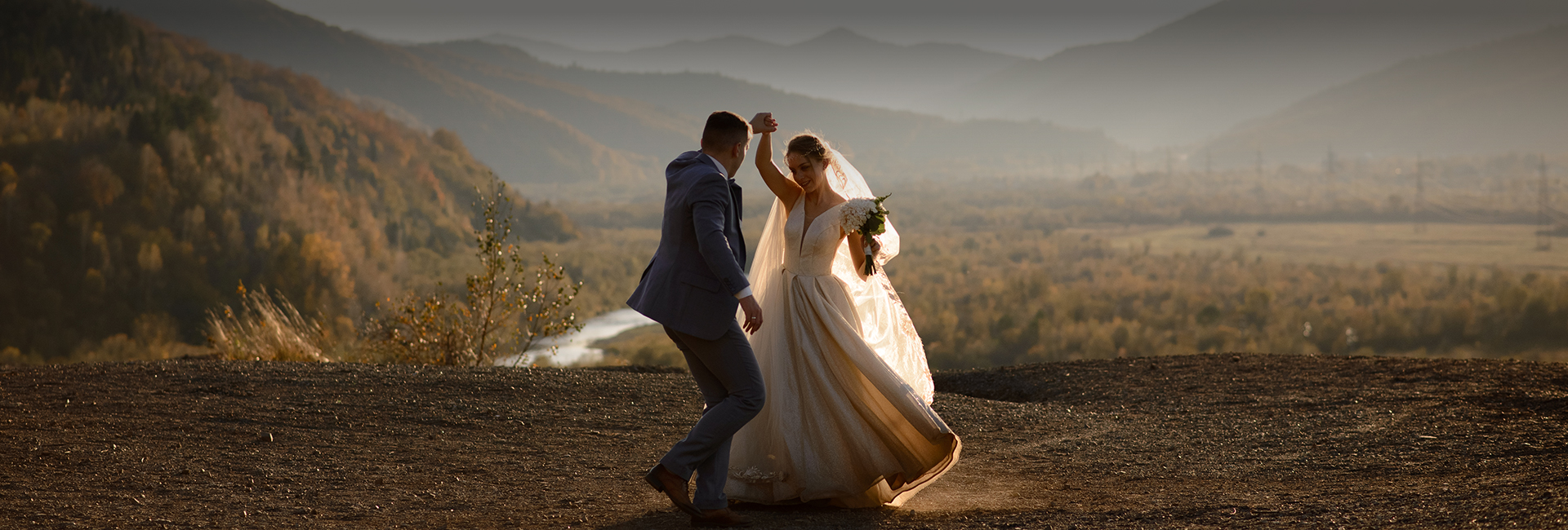 a man and woman dancing on a hill