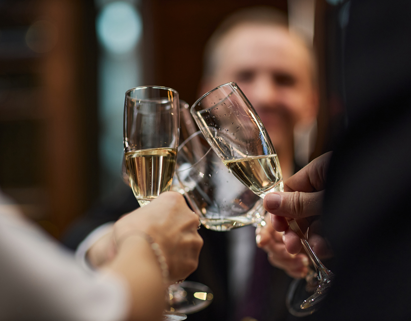 a group of people clinking champagne glasses