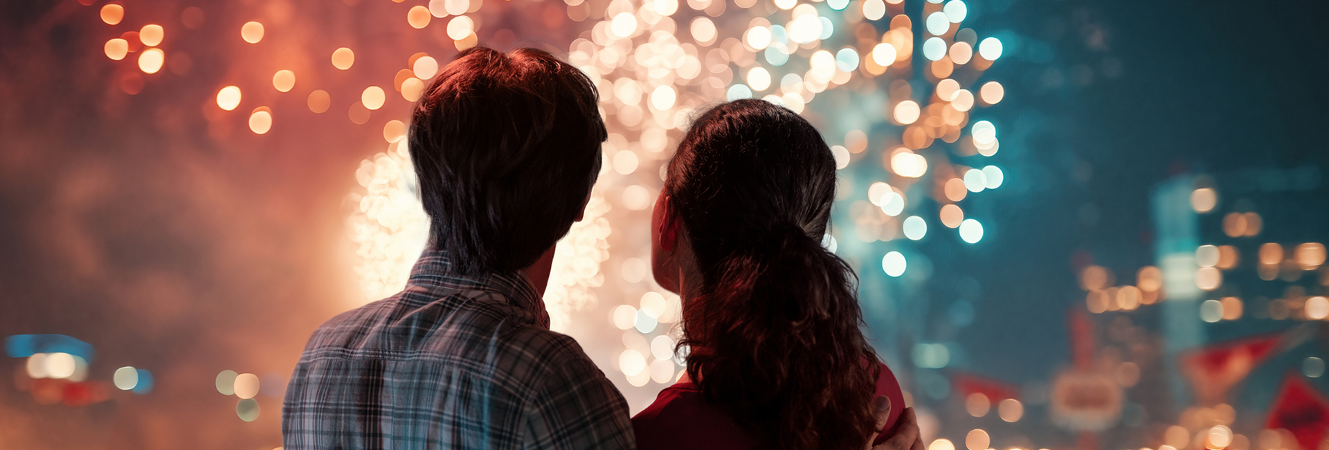 a man and woman looking at lights