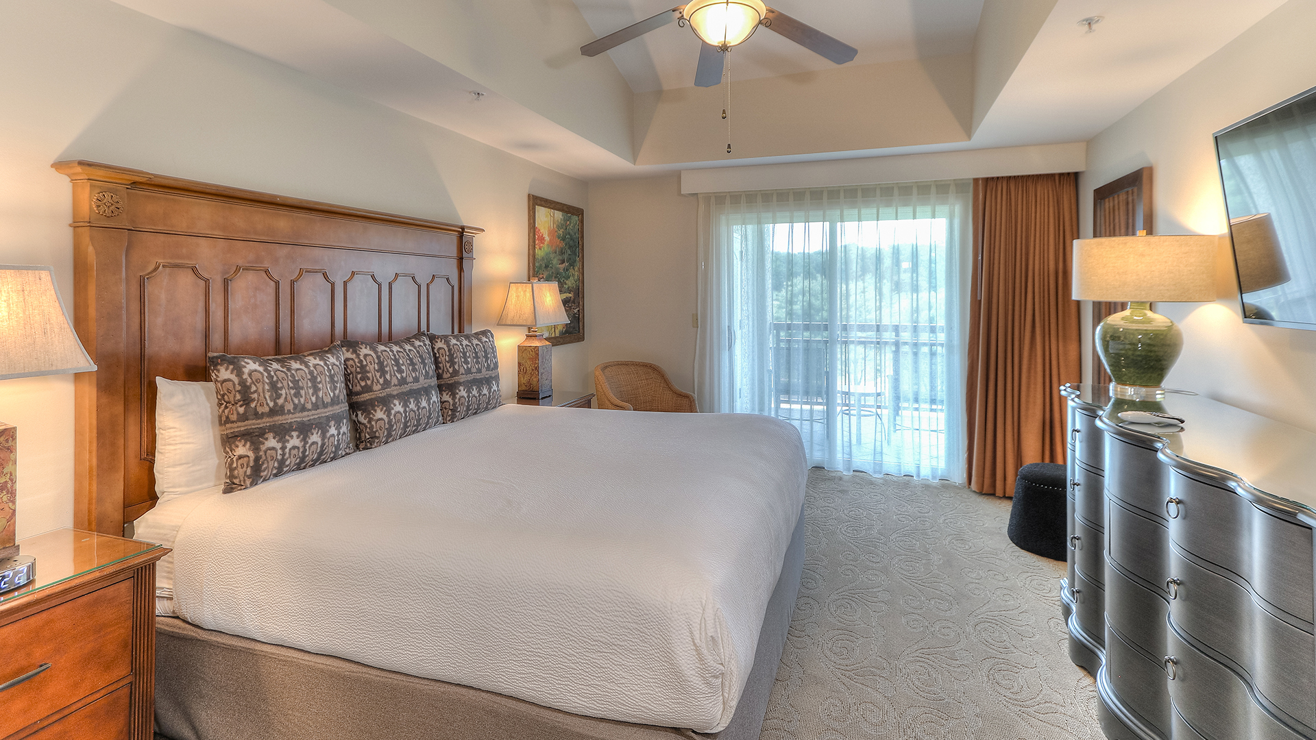 a bedroom with a bed and a ceiling fan